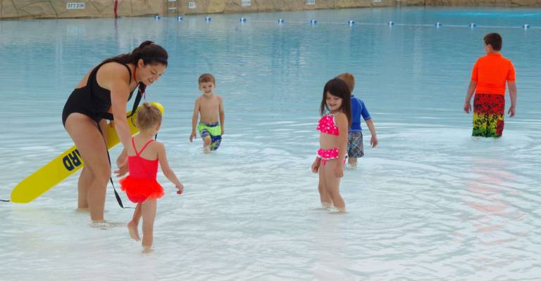 Certified Life Guard and Swimming Instructor Anna Sweeney of Highland Lakes helped the young children with the their first swimming lesson and taught them to be relaxed in the water of the Hightide Wavepool at Action Park.