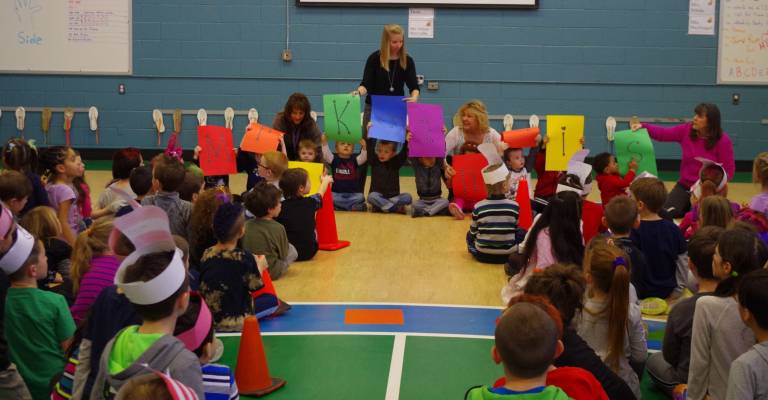 Preschool students held up cards that spelled out the message that Walnut Ridge School Counselor Nicole Keane won the award.