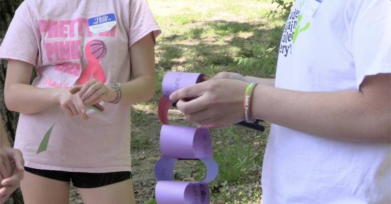 Students wrote messages on a piece of paper, which was turned into a chain and read aloud as a poem. (Photos provided)