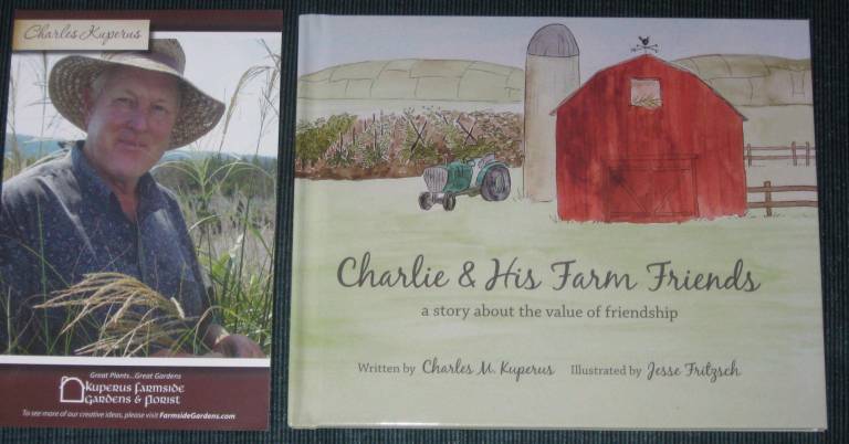 The late Charles Kuperus and a copy of his book Charlie and His Farm Friends are on display at both the supply and garden shops.