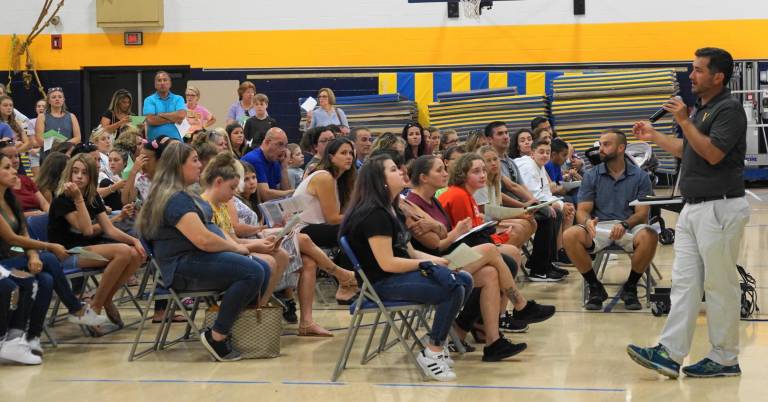 Physical Education Teacher Kieran Killen speaks with parents and students