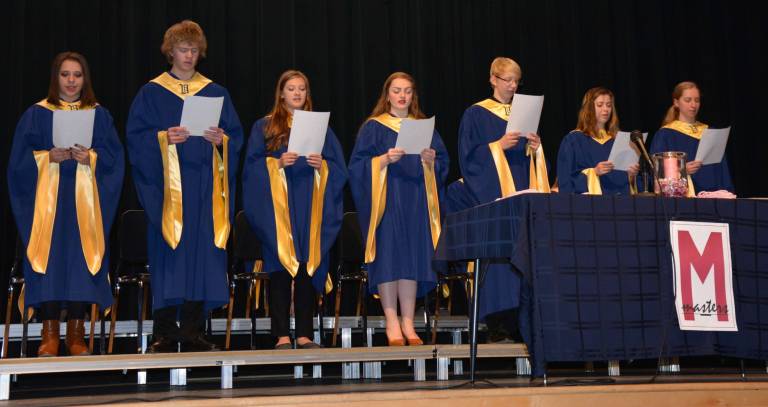 New Tri-M Inductees recite their pledge. From left, Inductees were Brittany Gaule, David MacMillan, Erika McNally, Emily Moreno, Ryan Shinall, Allison Specht and Rose Wolthoff.