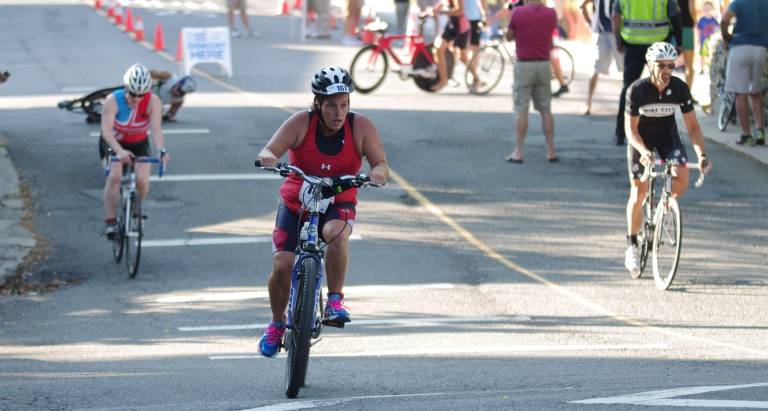 Triathlete Laura White of Newton pedals during the cycling part of the triathlon. White finished in 138th place overall with a time of 1:40:57.