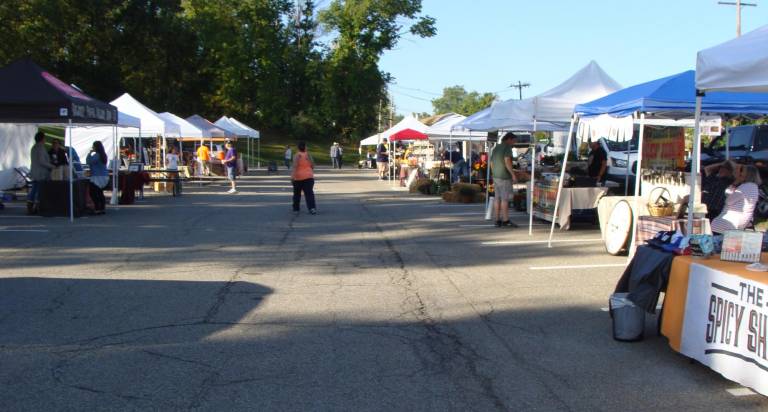 The main alley of the Vernon Farmers Market began to fill after a 9 am start