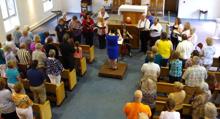 Choral Society holds concert The audience stands as the Community Choral Society sings our national anthem, þÄúThe Star-Spangled BannerþÄù by Francis Scott Key.