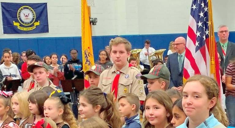 Adam Wien (center) leads the Boy Scout color guard at Valley Road School’s annual Salute to Veterans Program in 2019 (Photo provided)
