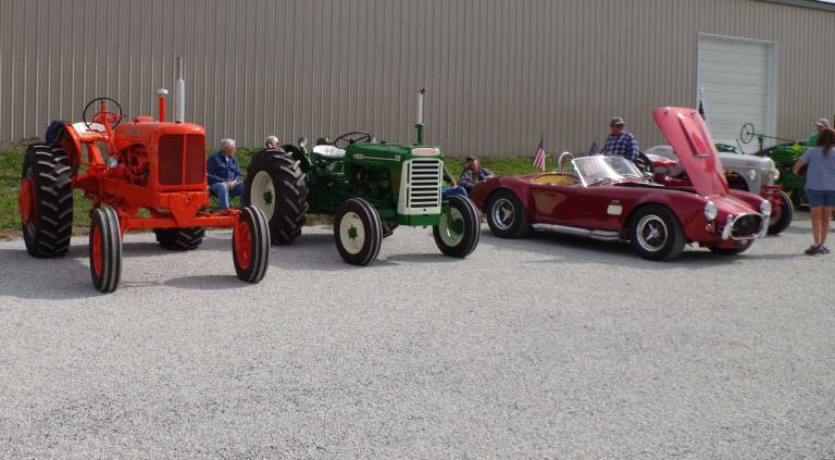 Vintage tractors were on display along with a red 1965 Shelby Cobra with a 427 cubic inch engine. The car is capable of reaching 187 miles per hour.