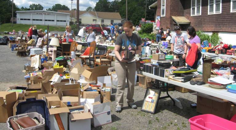 Gently used and bargain wise items line the Faith with Love Fellowship Church parking lot.