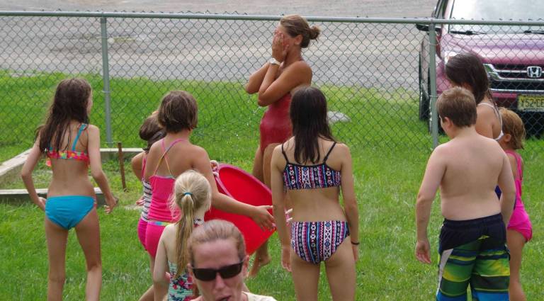 Following the water balloon toss, rather than using Gatorade, the kids poured a large bucket of cold water on head lifeguard Zoe Smolder.