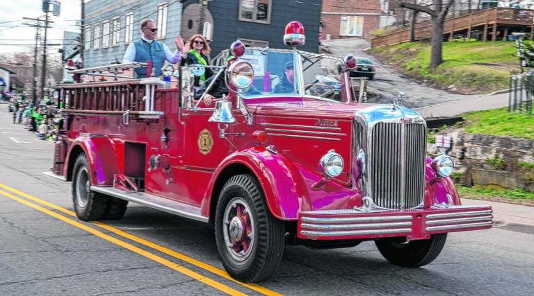 Jessica Caldwell, grand marshal of the parade, waves from an old firetruck. She has been Newton’s planner since 2008. Her ancestors immigrated to New Jersey from Dublin, Ireland.