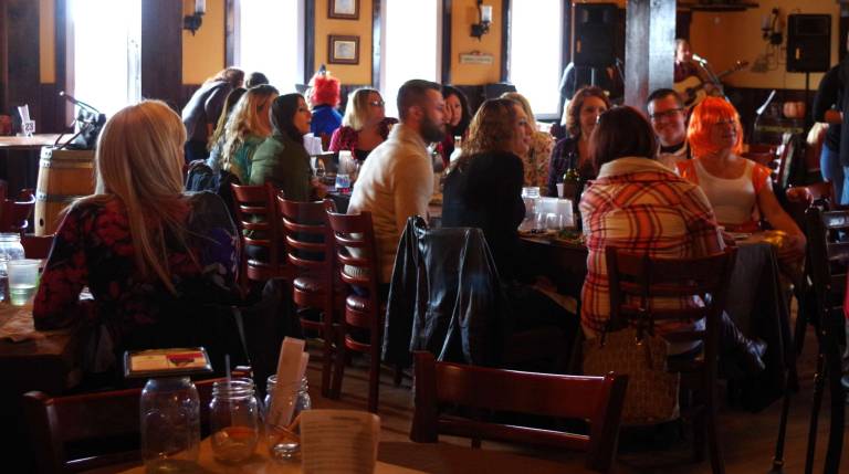 People sit and eat at Cava Winery's Halloween Costume contest.