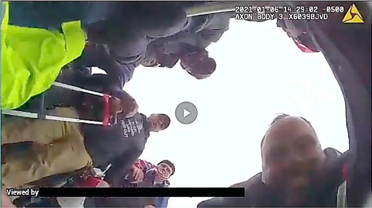 Ex-NYPD officer and Marine charged in violent Capitol attack Federal authorities said Thomas Webster, pictured in the lower right, lunges at the officer and tackles him to the ground. Authorities said the assault on the ground lasts approximately ten seconds.