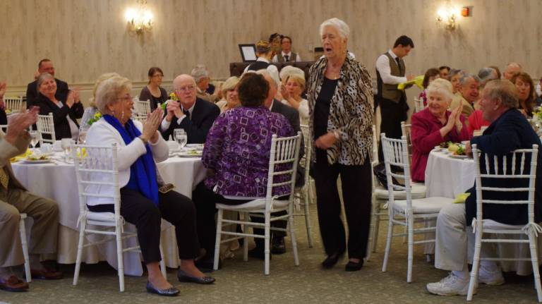 A very surprised Vernon Senior of the Year Pat Reilly heads toward the podium.