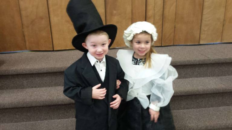 Young students learn about former president Kellen Kyzer and Reese Nichols are pictured in their costumes.