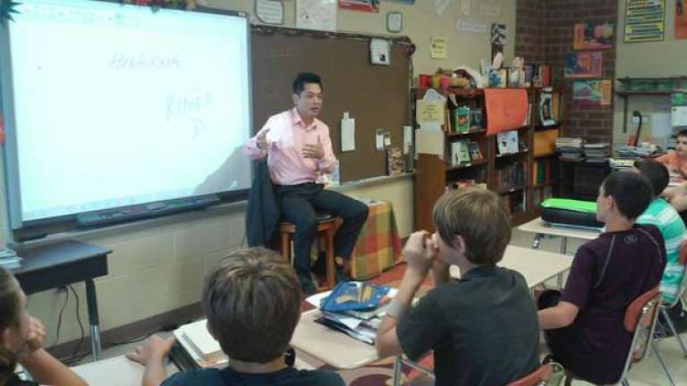 Kingo Wong, owner of Wings restaurant in Vernon, talks to Glen Meadow Middle School students.