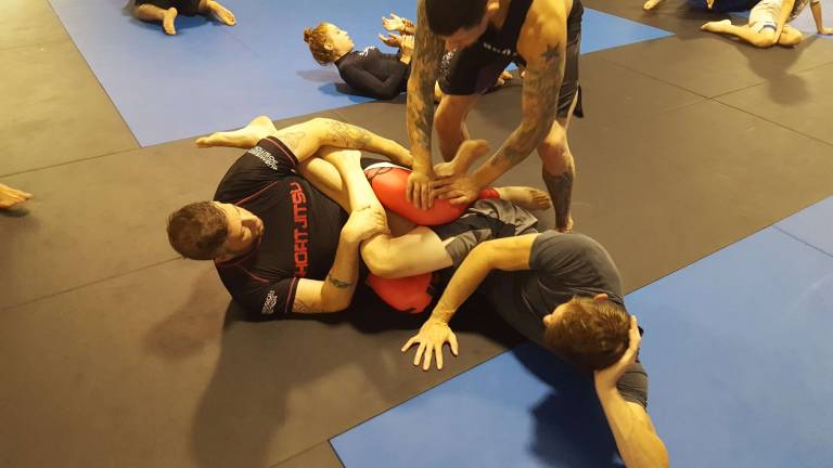 Miller Bros. hosts seminar, BBQ Coach Mike Pagano adjusts the technique of Ray Carroll (left) as he drills a technique on his partner Justin Zinn (right).