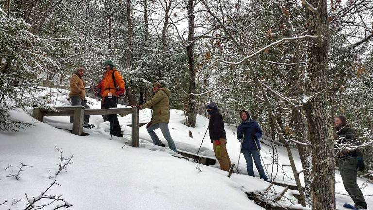 Learn the basics of snowshoeing Staffers on the Pocono Environmental Education Center's Tumbling Waters Trail (PEEC Facebook page)