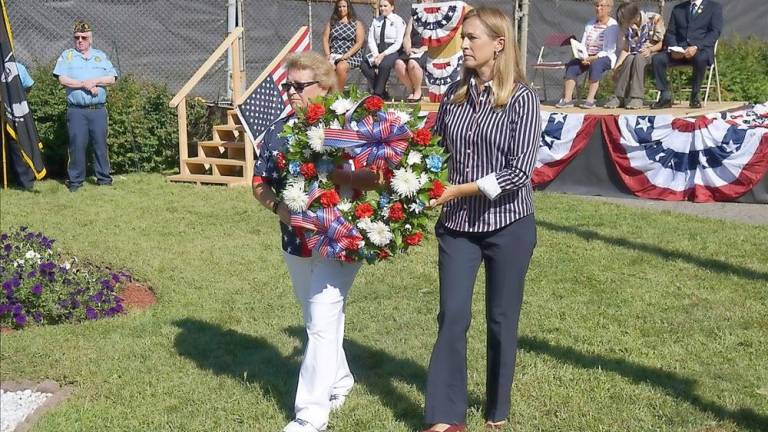 Mayor Patricia Zdichocki (left) and U.S. Rep. Mikie Sherrill carry the 9/11 wreath (Photo by Vera Olinski)