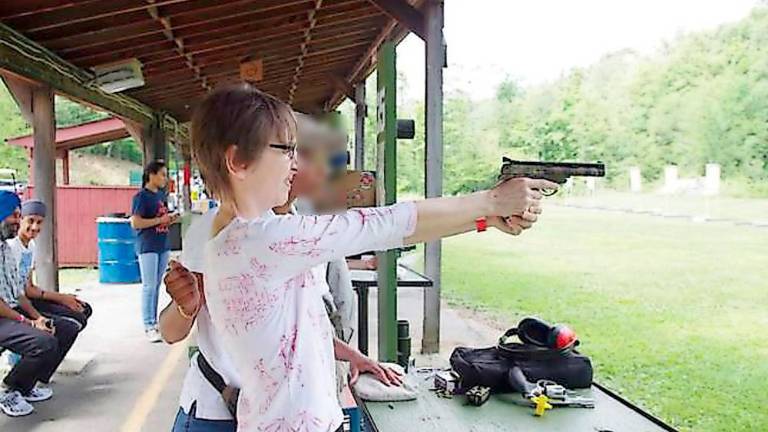 Lawsuit threats nix gun safety ordinance drafted after stray bullets hit Glen Harbor Anita Collins of Hamburg with handgun instructor Genesis Liu during a past Family Day at Cherry Ridge Range (Photo by Chris Wyman)