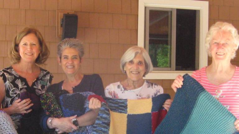 Some knitting and crocheting club members display their ready for distribution products. From left, Deb Piccirillo, Liliana Pappas, Elaine Kuntz and Barbara Fimia.