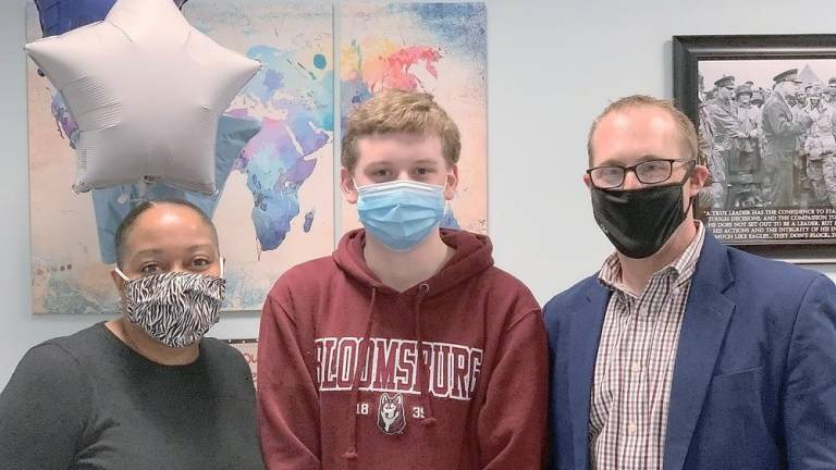 Valley Road School Principal Alicia Finklea-DiCataldo, eighth-grader Adam Wien, and District Superintendent Steven Hagemann take a break from lunch to smile behind their masks for a photo (Photo provided)