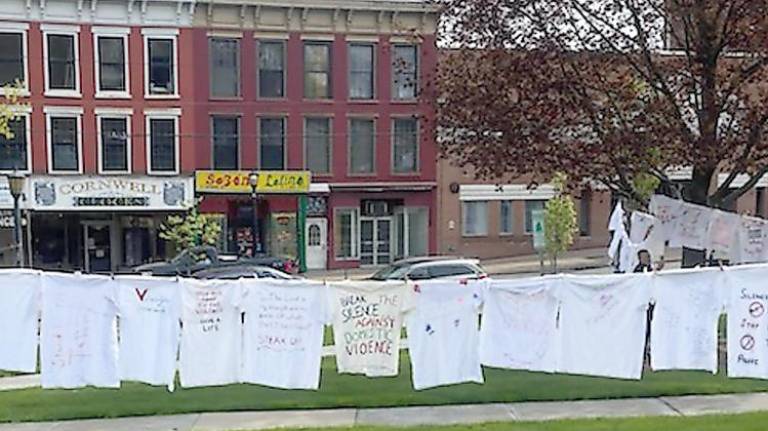 Tee-shirts hanging in the Newton Green help survivors “air out their dirty laundry” (Photo by Laurie Gordon)