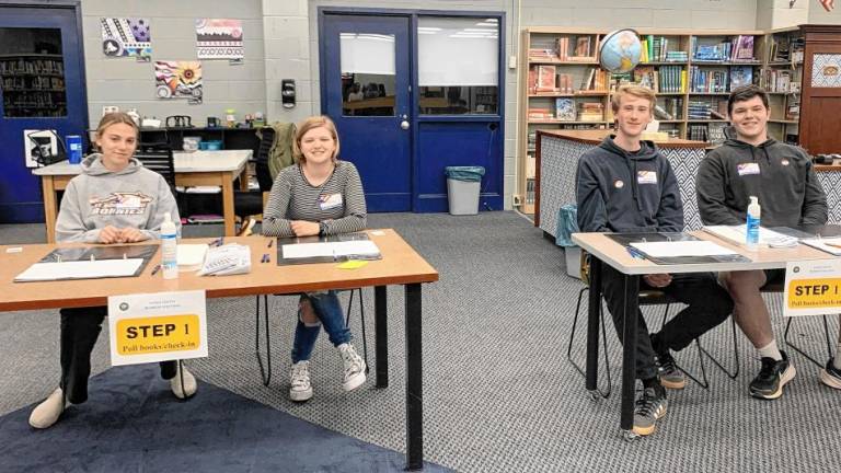 Students take the part of poll workers as part of the simulation. Those age 18 and older are eligible to be poll workers in a regular election. Several applied for a position. (Photo provided)