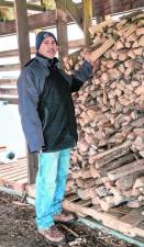MS1 Volunteer Paul Lamaila stands by the wood pile used to fuel the maple sugaring process at Lusscroft Farm in Sussex. (Photos by Nancy Madacsi)