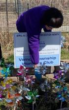 Judy Phillips, treasurer of the Vernon Township Woman’s Club, “plants” pinwheels to increase the community’s consciousness of the need to prevent child abuse and neglect.