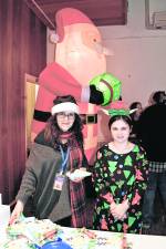 <b>Michelle Tagliabue and Katie Healy of Wantage stand in front of a Santa inflatable.</b>