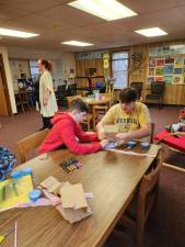 From left, Quinn McCully, 12, of Newton and James Staab, 14, of Wantage work on a protective casing for their egg.