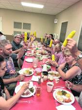 <b>Diners toast corn on the cob.</b>