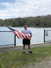 Sgt. Joseph Calcagno is running Old Glory around Highland Lake every day to raise money for local hospitals. Photo credit: Kate Drago