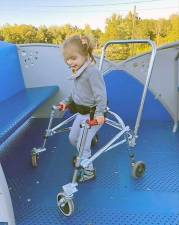 Meg Crowley Demsak’s daughter enjoys the new all-abilities glider at the Mildred Harden Playground (Photo courtesy of Meg Crowley Demsak)