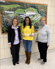 Vernon Township High School Principal Lindsay LeDuc, center, holds a check presented to the high school by Vernon Township Historical Society trustee Nancy Adams, right. At left is school board president Kelly Mitchell. (Photo provided)