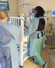 Nurses and a doctor (in green pants) in the isolation unit just before Brittany and her son were able to leave it.