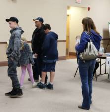 Poll workers check in citizens to vote at the Vernon Township High School.