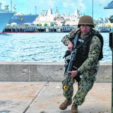 Logistics Specialist 2nd Class Juan Bautista, a native of Vernon who is assigned to the USS Boxer, responds during an anti-terrorism force protection drill. The Boxer is a Wasp-class amphibious assault ship homeported in San Diego. (Photo by Seaman Tyler Miles)