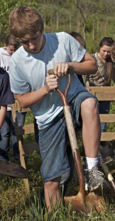 Sean O'Brien from Glen Meadow Middle School puts his foot into it, digging for artifacts at the Black Creek Site in Vernon.