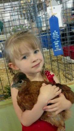 <b>Murphy at the fair as a child, with a chicken she entered in the Open Poultry Show.</b>