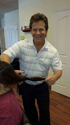 George Michael snips a pony tail for Locks of Love. The popular stylist has returned to the area after a hiatus working elsewhere.