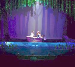 Ariel sits in a boat with Prince Eric, hoping to be kissed.