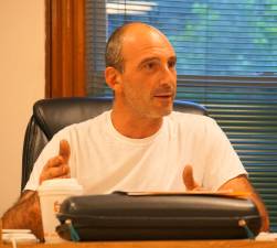 PHOTO BY VERA OLINSKI Councilman Anthony Nasisi reviews heater and boiler information for borough hall and the historical building.