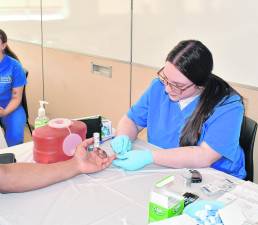 Emma Verniero of Newton checks blood for cholesterol.