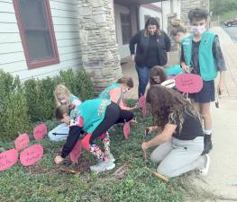 Girl Scouts plant pink pumpkins outside the Hardyston Municipal Building entrance (Photo by Laura J. Marchese)