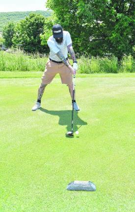 <b>Tim O'Neill of Sussex golfs.</b>