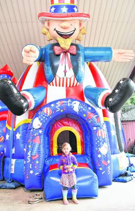 <b>Juniper Haber of Byram poses in front of an inflatable.</b>