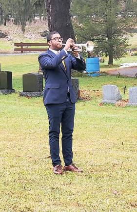 Bryce Grier plays Taps with his trumpet.