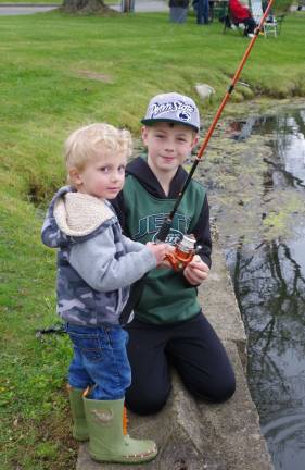 Tyler Paluzzi, 11, of High Lakes helps his little brother Keegan, 3, learn how to fish.