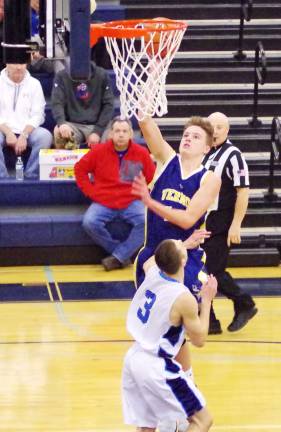Vernon's Sean Sabol soars high towards the basket with the ball.